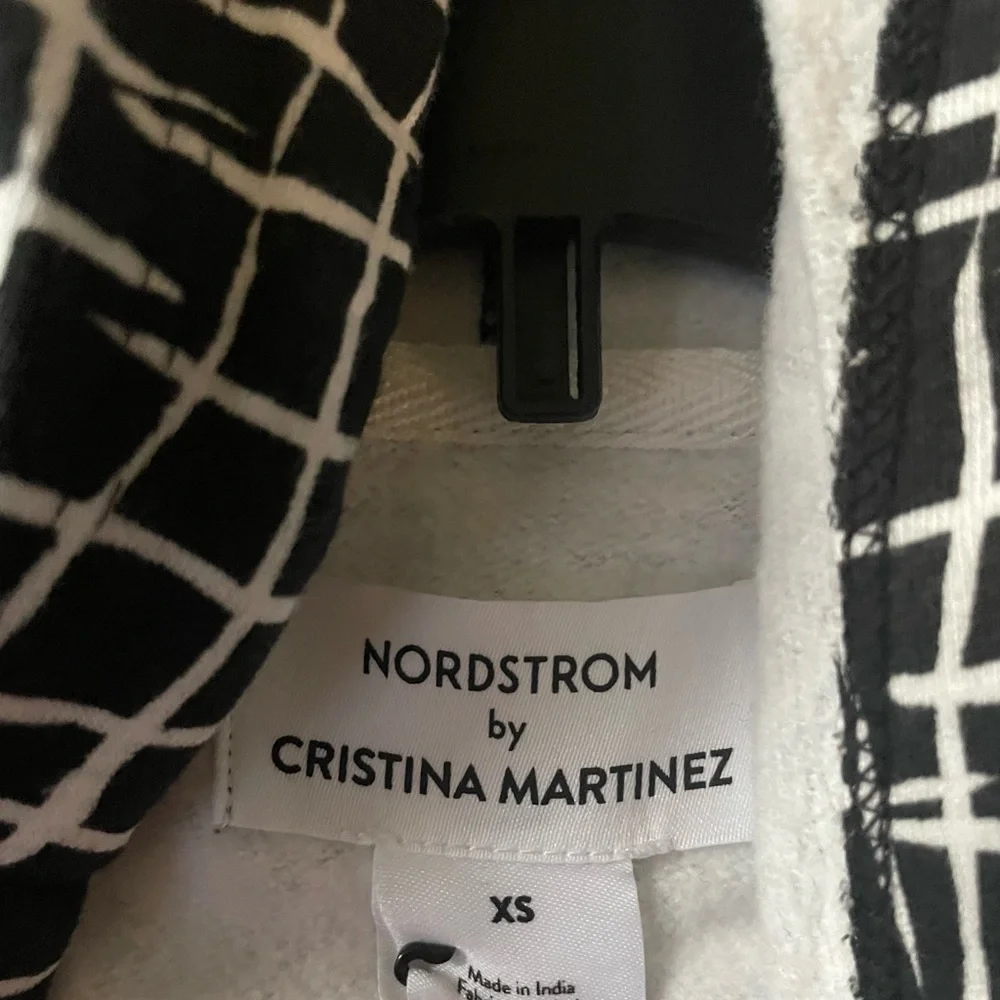 𝅺CRISTINA MARTINEZ GENDER INCLUSIVE GRAPHIC FLEECE HOODIE IN BLACK LADDE…